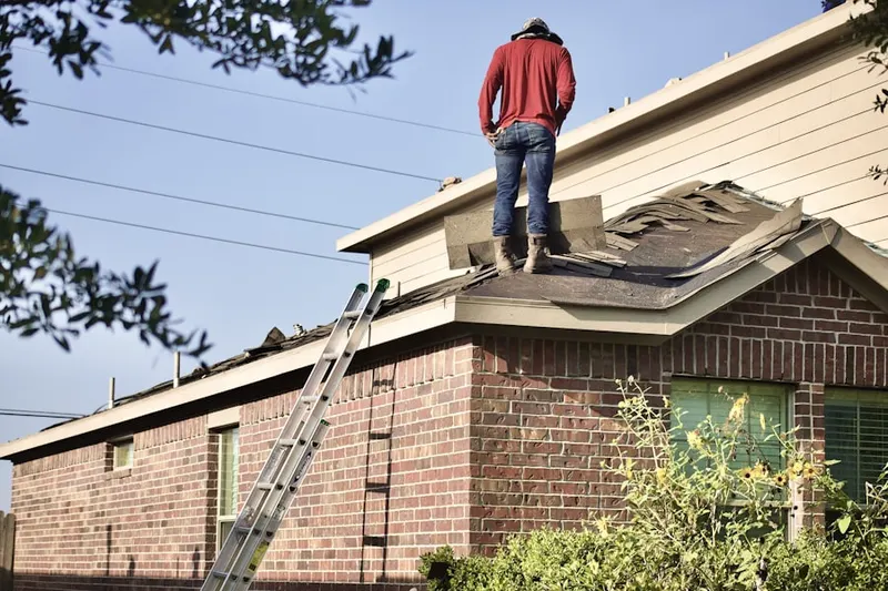 Professional roofer working on a residential roof in Kato